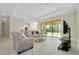 Bright, open living room with tile floors and large sliding glass doors to the backyard at 20794 Valprato Ct, Venice, FL 34293
