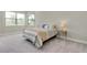 Bedroom featuring carpeted floors, two windows with blinds and bedside tables with lamps on each at 20794 Valprato Ct, Venice, FL 34293