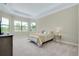 Spacious main bedroom featuring tray ceiling, carpeted floors, and windows offering plenty of natural light at 20794 Valprato Ct, Venice, FL 34293