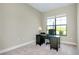 Bright office space with natural light, neutral walls, and dark wood desk with office chair and carpeted floors at 20794 Valprato Ct, Venice, FL 34293