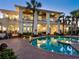 Elegant estate with a large pool, lush landscaping, and outdoor lighting for evening enjoyment at 2110 Casey Key Rd, Nokomis, FL 34275