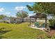 Backyard view with a gazebo, pool, and lush landscaping, ideal for outdoor living at 243 Gardenia Rd, Venice, FL 34293