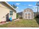 Backyard showcasing a shed, along with lawn, and various utilities at 308 Purdue Rd, Venice, FL 34293