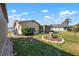 Backyard features a grass area and a landscaped area with a tree stump feature at 308 Purdue Rd, Venice, FL 34293