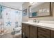 Charming bathroom with a decorative shower curtain, a large mirror, and stylish vanity at 308 Purdue Rd, Venice, FL 34293