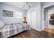 Cozy bedroom features wood-look flooring, a ceiling fan, and a large window at 308 Purdue Rd, Venice, FL 34293