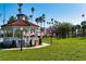 Charming gazebo in a park setting, surrounded by lush greenery, palm trees, and a manicured lawn at 308 Purdue Rd, Venice, FL 34293