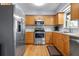 Bright kitchen featuring stainless steel appliances, wood cabinets, and ample counter space at 308 Purdue Rd, Venice, FL 34293