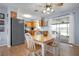 Cozy kitchen and dining area featuring wood cabinets, stainless steel appliances, and lots of natural light at 308 Purdue Rd, Venice, FL 34293