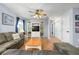 Comfortable living room with hardwood floors, ceiling fan, and built-in shelving for entertainment at 308 Purdue Rd, Venice, FL 34293