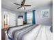 Bedroom with ceiling fan, wood floors, white dresser and white doors at 308 Purdue Rd, Venice, FL 34293