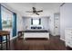 Spacious main bedroom with wood flooring, white furniture and a ceiling fan at 308 Purdue Rd, Venice, FL 34293