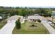 Aerial view of a charming single-story home with a well-manicured lawn, double garage, and inviting curb appeal at 31 Ramblewood St, Port Charlotte, FL 33953