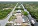 Aerial view of the community, canal, pool, boat dock, and backyard, all surrounded by lush greenery at 31 Ramblewood St, Port Charlotte, FL 33953