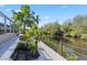 Lush landscaping along the canal creates a private backyard with room for gardening and relaxing by the water at 31 Ramblewood St, Port Charlotte, FL 33953