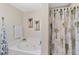 Bathroom featuring a soaking tub and a separate shower with a decorative curtain at 31 Ramblewood St, Port Charlotte, FL 33953