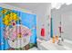 Fun bathroom with pop art shower curtain, modern vanity and fixtures, and a well-lit mirror at 31 Ramblewood St, Port Charlotte, FL 33953