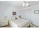 Bright bedroom featuring a ceiling fan, floral bedding, and a spacious closet at 31 Ramblewood St, Port Charlotte, FL 33953
