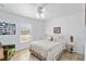 Cozy bedroom featuring natural light, ceiling fan, and a comfortable bed with floral accents at 31 Ramblewood St, Port Charlotte, FL 33953