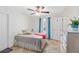 Serene bedroom with ceiling fan, tiled floor, pool view, and neutral decor at 31 Ramblewood St, Port Charlotte, FL 33953