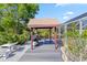 Dockside outdoor kitchen with grill, countertop seating, and outdoor lighting for entertaining next to water at 31 Ramblewood St, Port Charlotte, FL 33953
