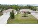 Spacious home with manicured lawn, two garages, and a fenced backyard featuring a sparkling in-ground pool at 31 Ramblewood St, Port Charlotte, FL 33953