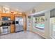 Bright kitchen with stainless appliances, tile floors, and a view of the pool through large windows at 31 Ramblewood St, Port Charlotte, FL 33953