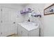 Functional laundry room with modern appliances, shelving for storage, and a clean, organized design at 31 Ramblewood St, Port Charlotte, FL 33953