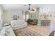 Spacious living room with tile flooring, a ceiling fan, and comfortable seating plus a breakfast bar at 31 Ramblewood St, Port Charlotte, FL 33953