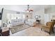 Bright living room with tile flooring, a ceiling fan, and a comfortable seating area for relaxation at 31 Ramblewood St, Port Charlotte, FL 33953