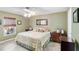 Inviting main bedroom with a large window, dresser, and floral bedspread at 31 Ramblewood St, Port Charlotte, FL 33953