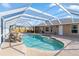 Enjoy the beautiful pool with a rock waterfall feature, under a screened enclosure, for year-round outdoor living at 31 Ramblewood St, Port Charlotte, FL 33953
