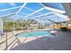 Screened in pool with a view of the water and dock at 31 Ramblewood St, Port Charlotte, FL 33953