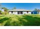 Home exterior featuring a well-maintained lawn, a patio, and mature landscaping at 3447 Nadasky Ave, North Port, FL 34288