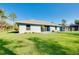 Beautiful home exterior showcasing a well-manicured lawn, a patio, and mature landscaping at 3447 Nadasky Ave, North Port, FL 34288