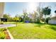 Expansive backyard featuring lush lawn, mature trees, and plenty of space for outdoor activities at 3447 Nadasky Ave, North Port, FL 34288