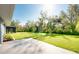 Spacious backyard featuring a well-manicured lawn, mature trees, and a patio area for entertaining at 3447 Nadasky Ave, North Port, FL 34288