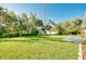 Lush backyard featuring mature trees, a storage shed, and a well-maintained lawn at 3447 Nadasky Ave, North Port, FL 34288