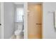 Bright bathroom features a shower and toilet with tiled floors and window at 3447 Nadasky Ave, North Port, FL 34288