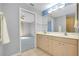 A bathroom is brightly lit and has a double sink vanity at 3447 Nadasky Ave, North Port, FL 34288
