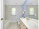 Bathroom with a large mirror, vanity with sink, toilet, and shower/tub combination, offering a functional layout at 3447 Nadasky Ave, North Port, FL 34288