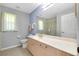 Bathroom with a large mirror, vanity with sink, toilet, and shower/tub combination, offering a functional layout at 3447 Nadasky Ave, North Port, FL 34288