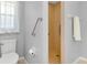 Bright bathroom features a shower and toilet with tiled floors and window at 3447 Nadasky Ave, North Port, FL 34288