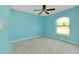 Cozy bedroom featuring a ceiling fan and an arched window providing natural light and a pleasant ambiance at 3447 Nadasky Ave, North Port, FL 34288