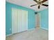 A bedroom with a closet, ceiling fan, and doorway to the other areas of the house at 3447 Nadasky Ave, North Port, FL 34288