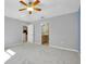 Neutral bedroom with carpet, ceiling fan and views to a bathroom and kitchen at 3447 Nadasky Ave, North Port, FL 34288