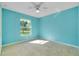 Bright bedroom featuring a ceiling fan and a large window offering great natural light and outdoor views at 3447 Nadasky Ave, North Port, FL 34288
