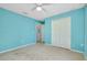 Spacious bedroom includes a ceiling fan, closet, and a door leading to other areas of the home at 3447 Nadasky Ave, North Port, FL 34288