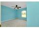 Cozy bedroom featuring a ceiling fan and an arched window providing natural light and a pleasant ambiance at 3447 Nadasky Ave, North Port, FL 34288