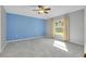 A spacious bedroom features plush carpeting, ceiling fan, and large window at 3447 Nadasky Ave, North Port, FL 34288